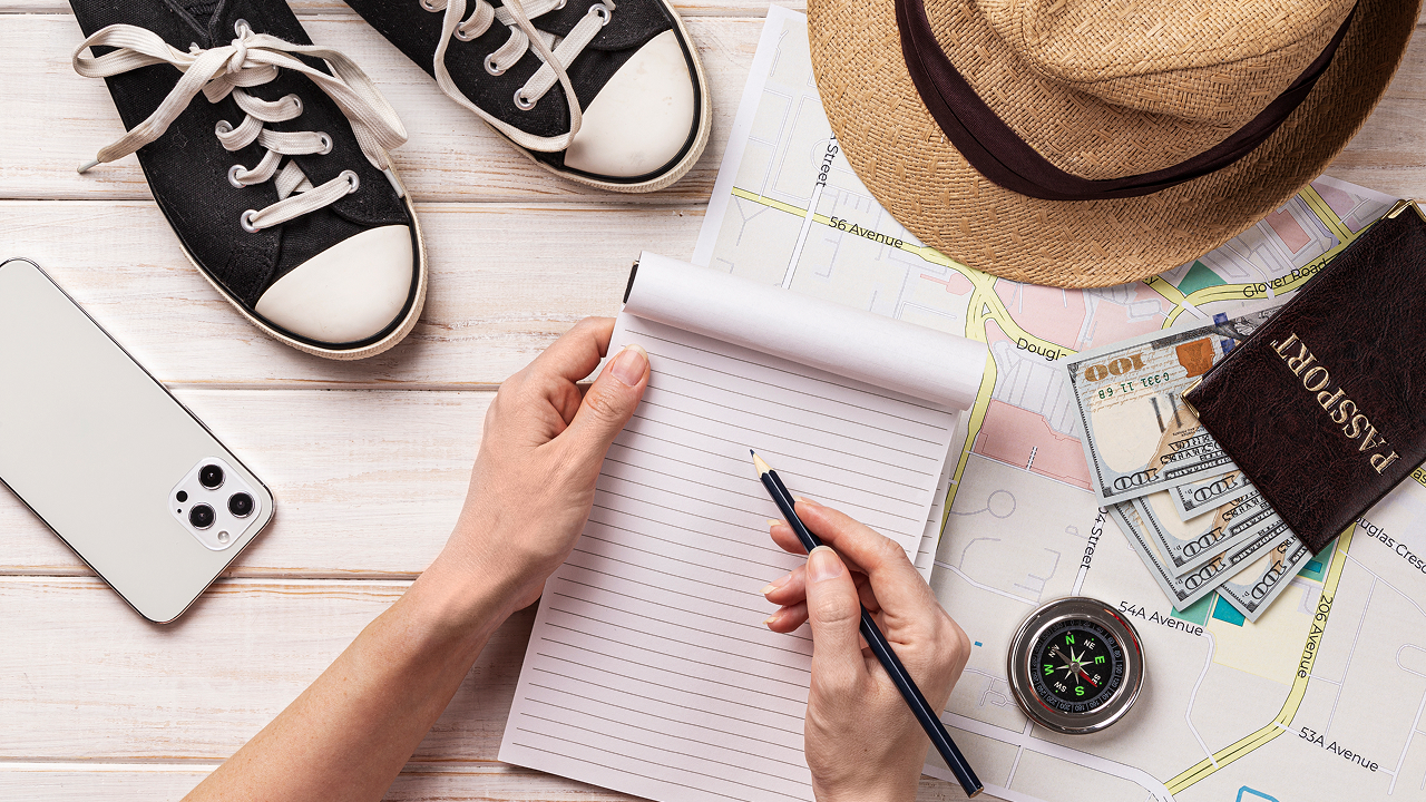 Top view in which a man is planning for a solo trip