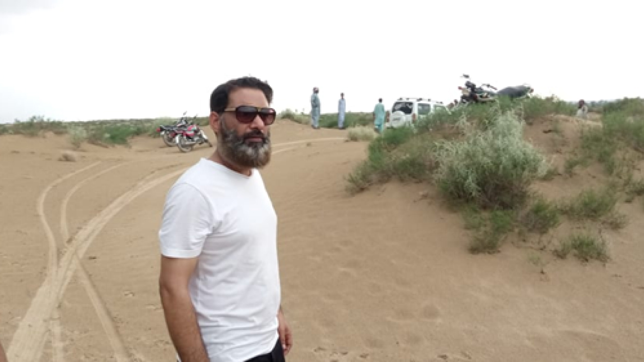 Side pose of a man wearing white t-shirt