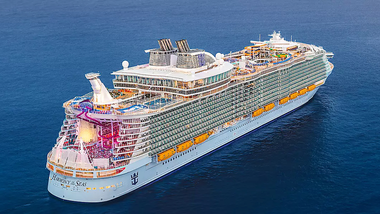 A large ship sailing on blue water, which is the biggest cruise ship in the world