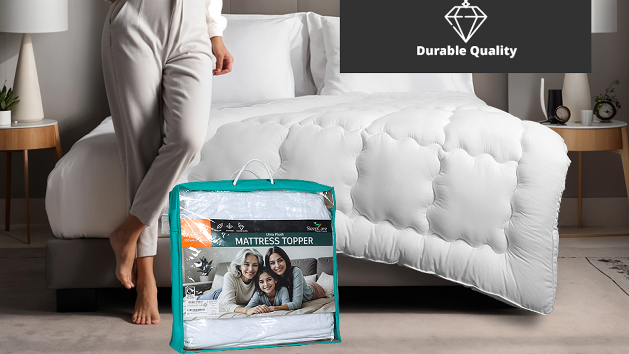 A white bed topper with the packaged mattress topper displayed