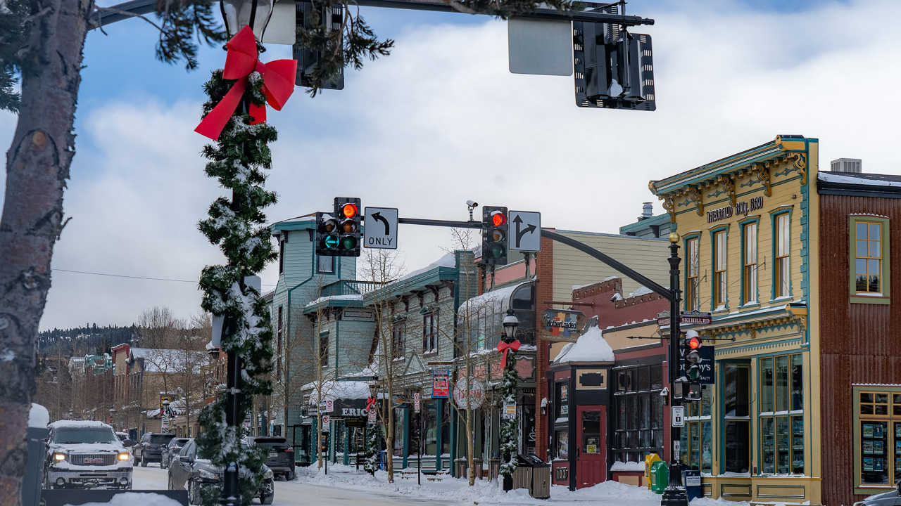Snowy small-town street with colorful shops