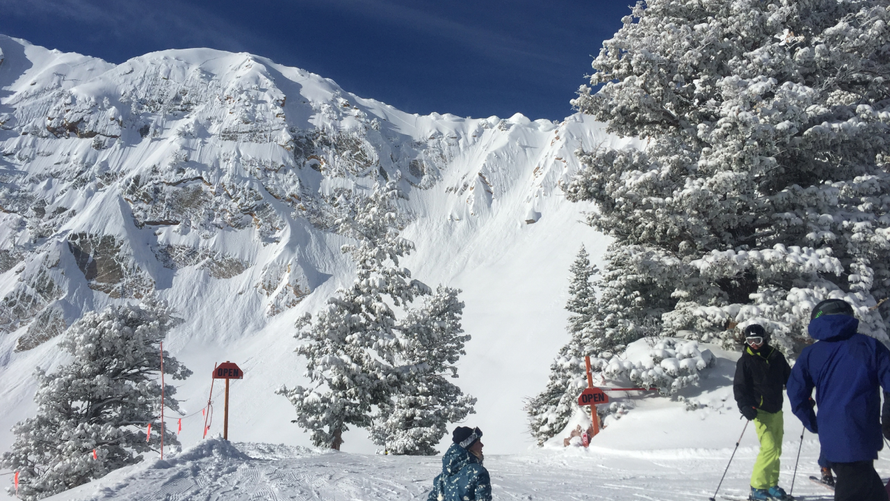 Snow-covered mountains with skiers skiing