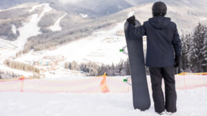 A guy holding a snowboard