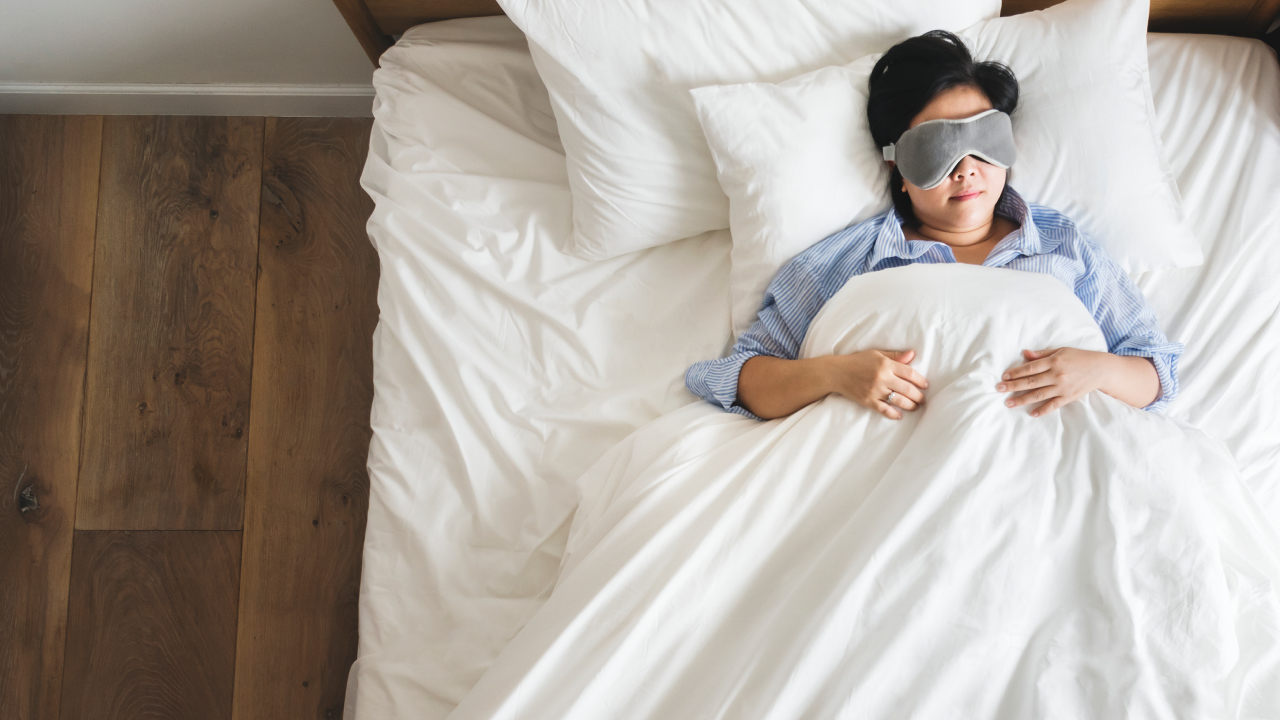 A woman is sleeping peacefully on the mattress topper
