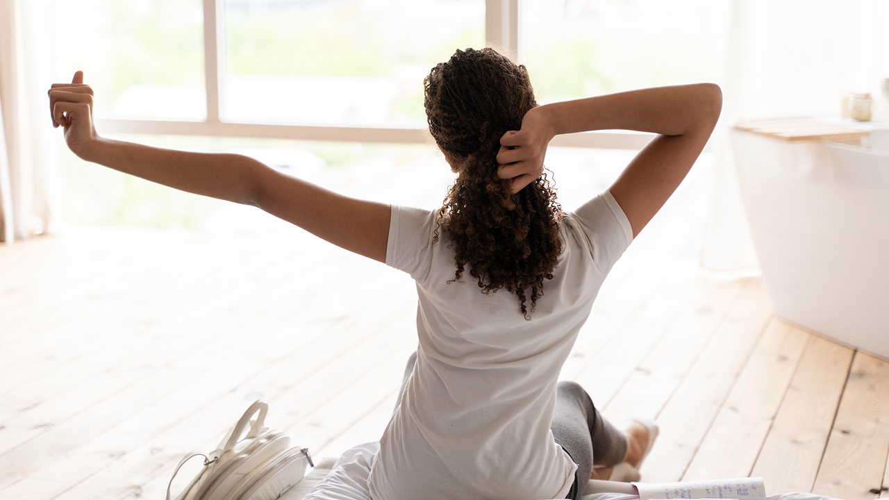 A back view of a girl stretching after sleep