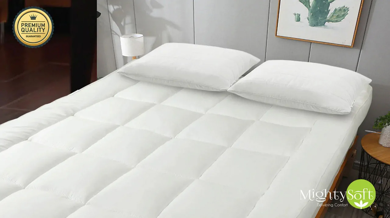 A white quilted mattress topper