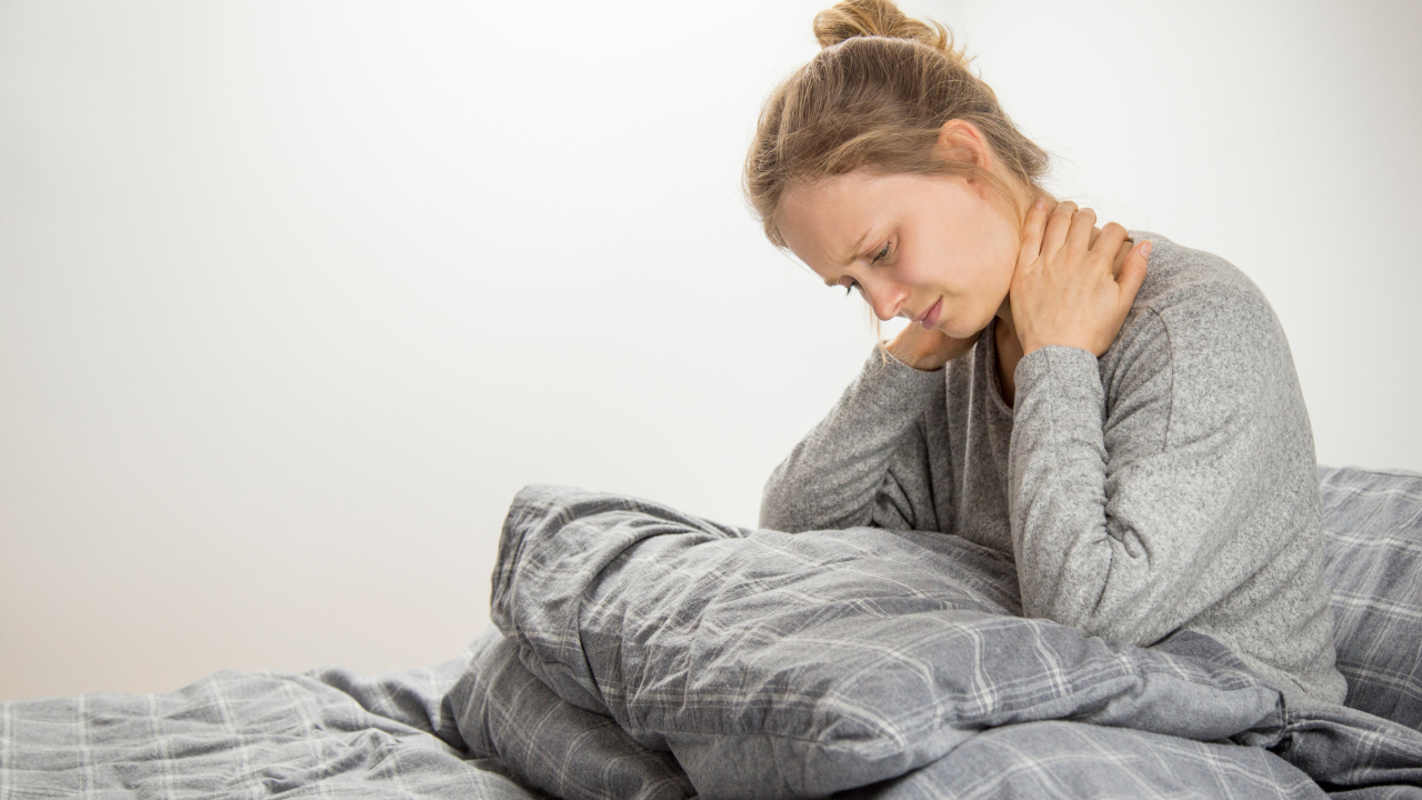 A girl having neck pain because of side sleeping