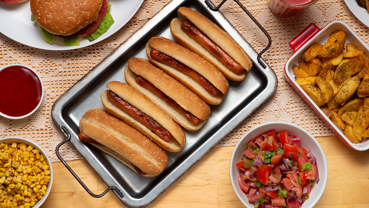 Top view of sausages placed on a metal baking tray