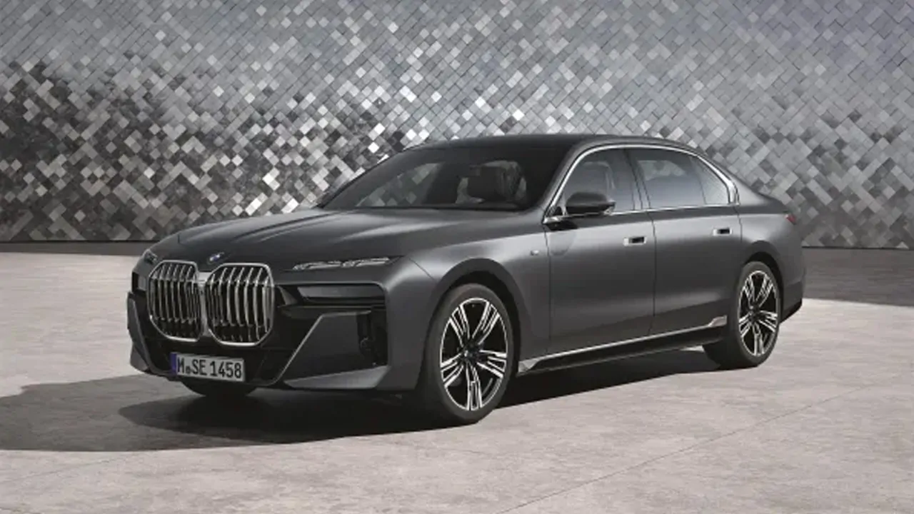 BMW 7 Series is standing in front of a fancy background