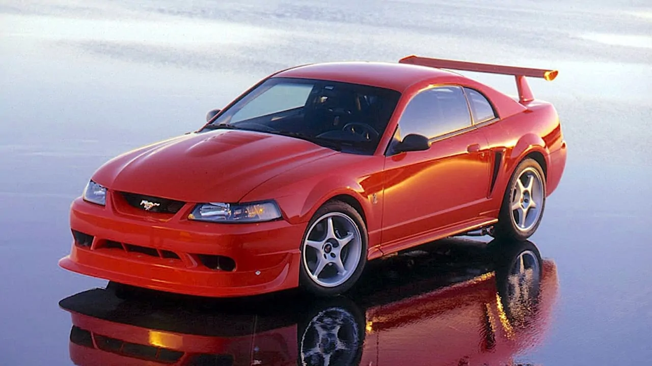 A beautiful red ford mustang standing on a reflecting floor