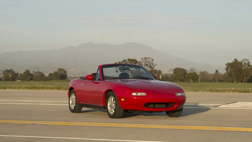 The red MX-5 (NA) standing on a road