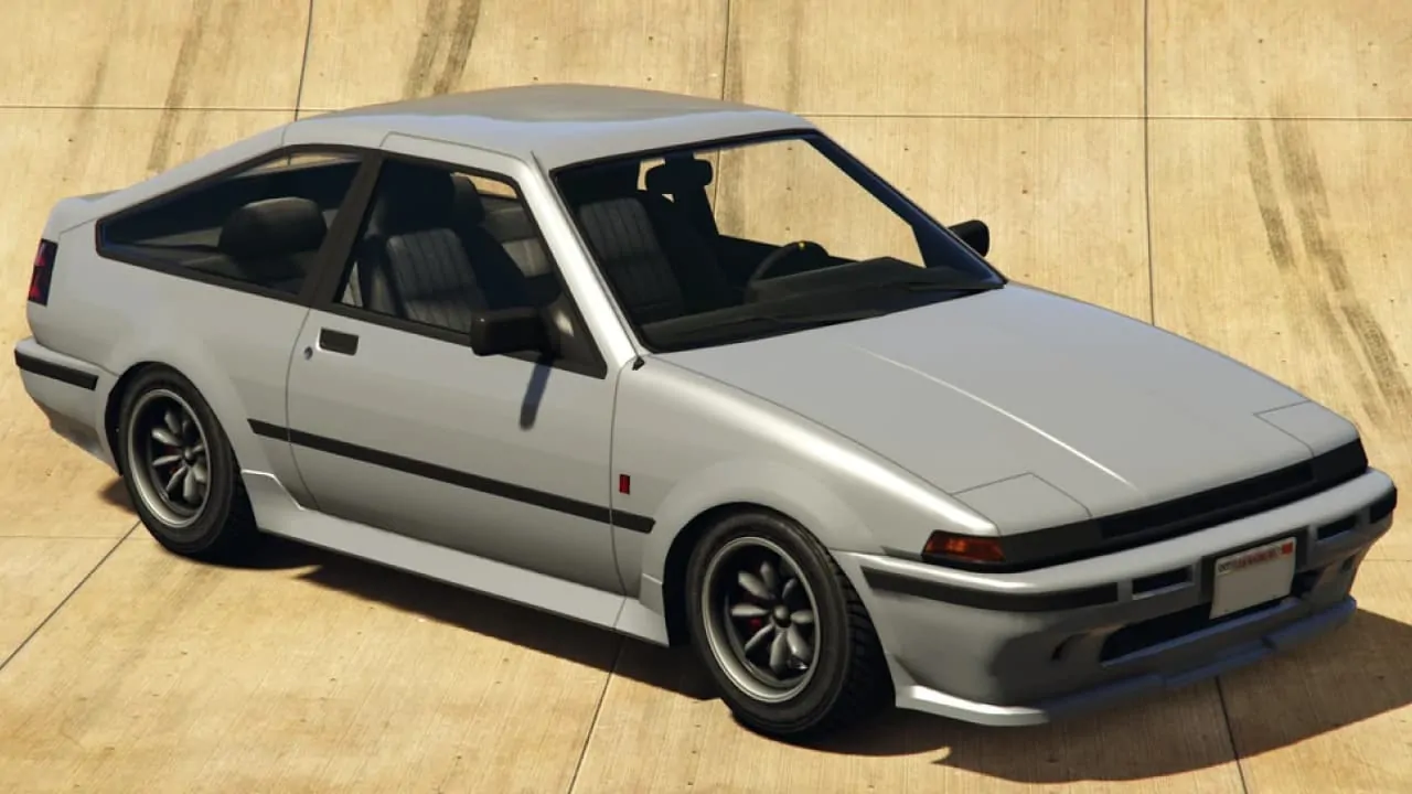 A grey Karin Futo GTX is parked on a wooden floor