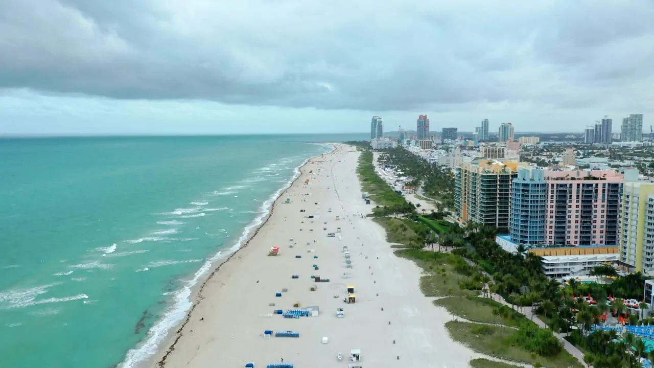 A Florida beach with buildings on the right side
