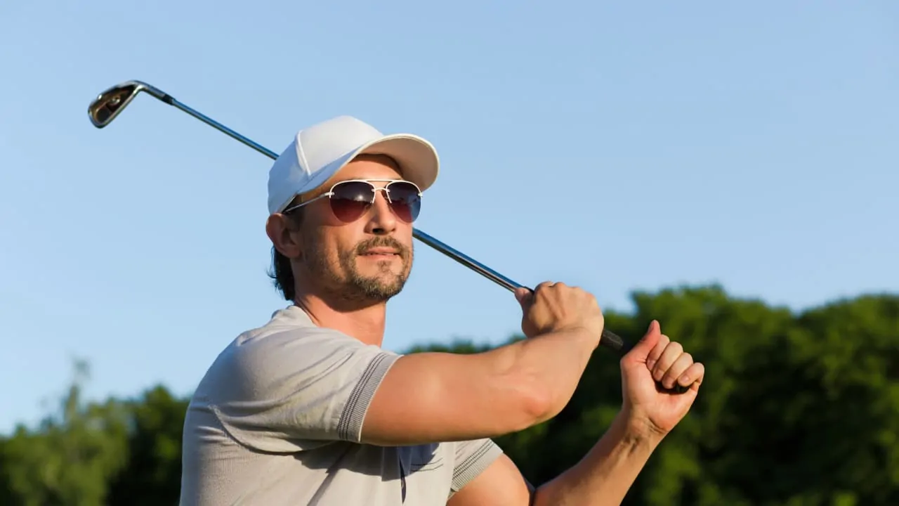 A young golfer is taking a shot, which is a great option for weekend getaways in Florida