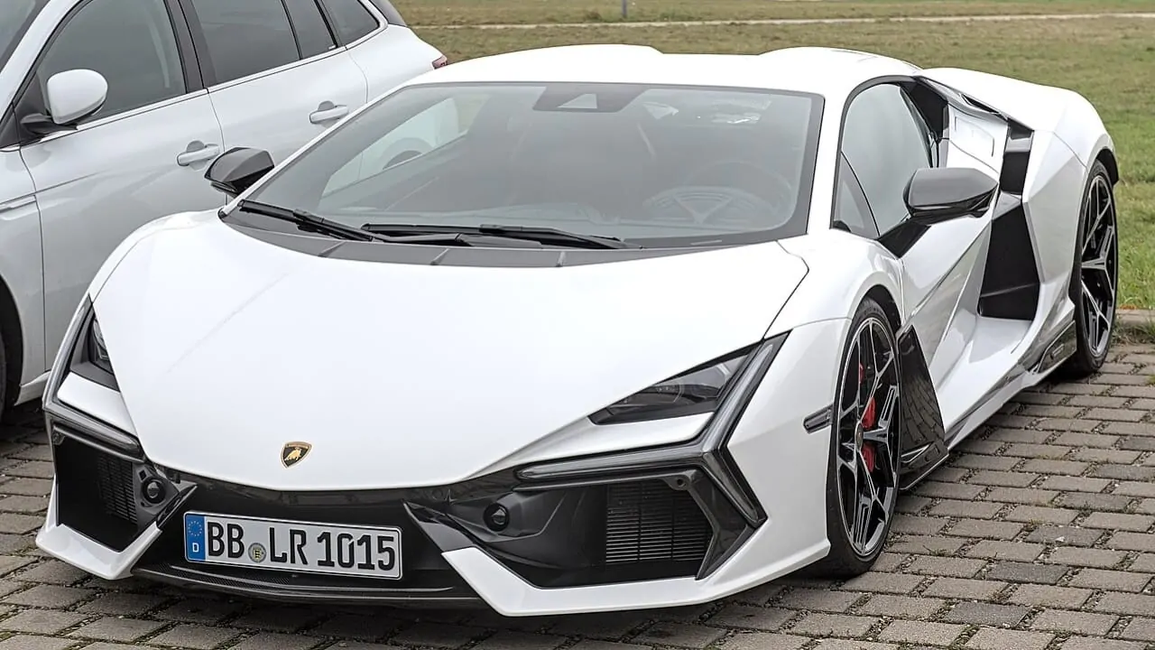 A white Lamborghini parked on a roadside