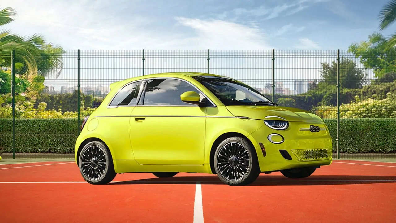 A little Fiat 500e in yellow color, smallest and cheapest electric motor