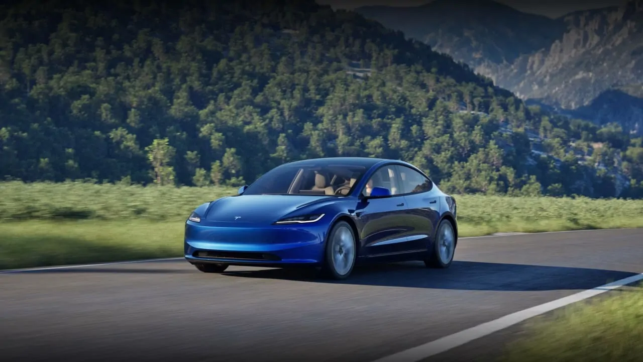 A Tesla Model 3 is crossing the road, it is one of the least expensive electric cars