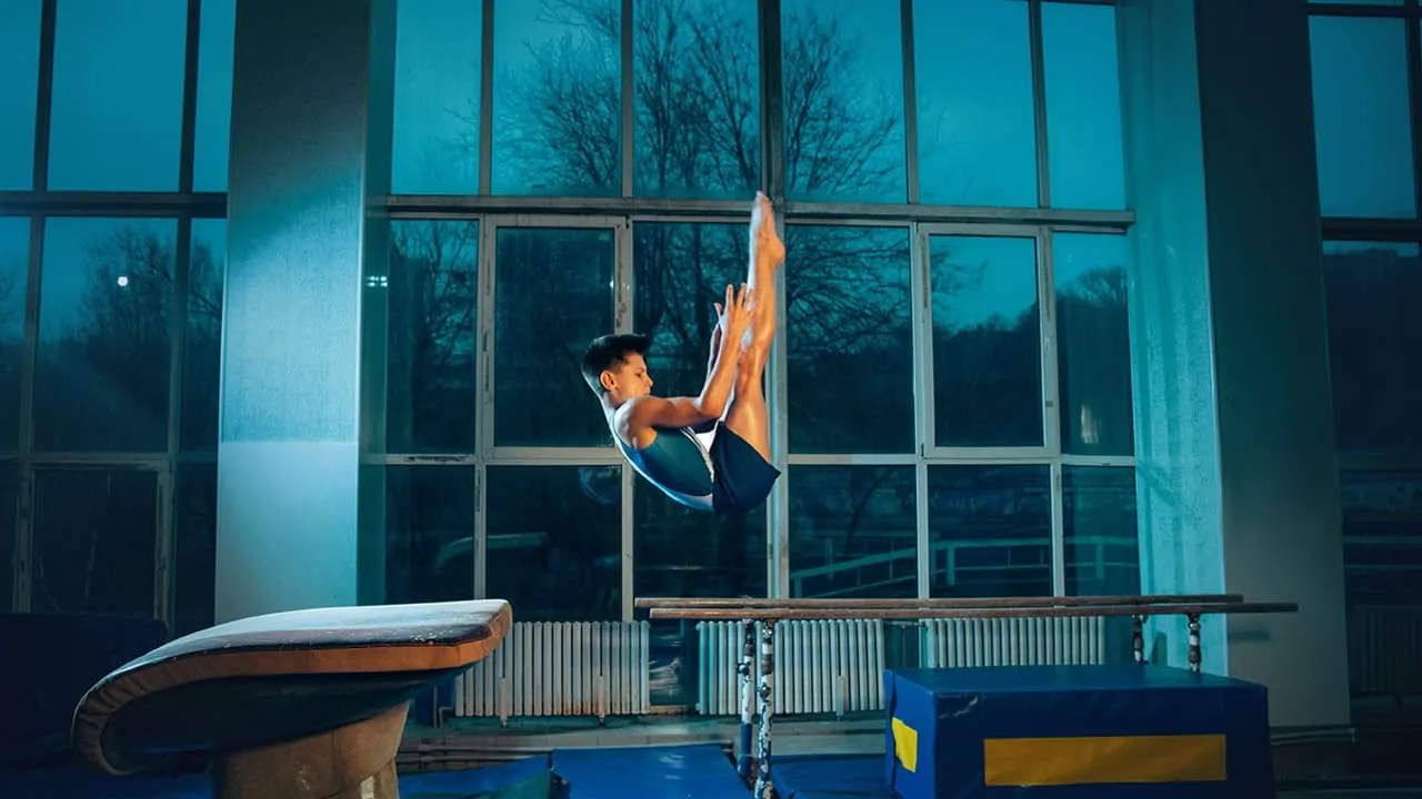 a male gymnast's capture in the air while doing flip jump
