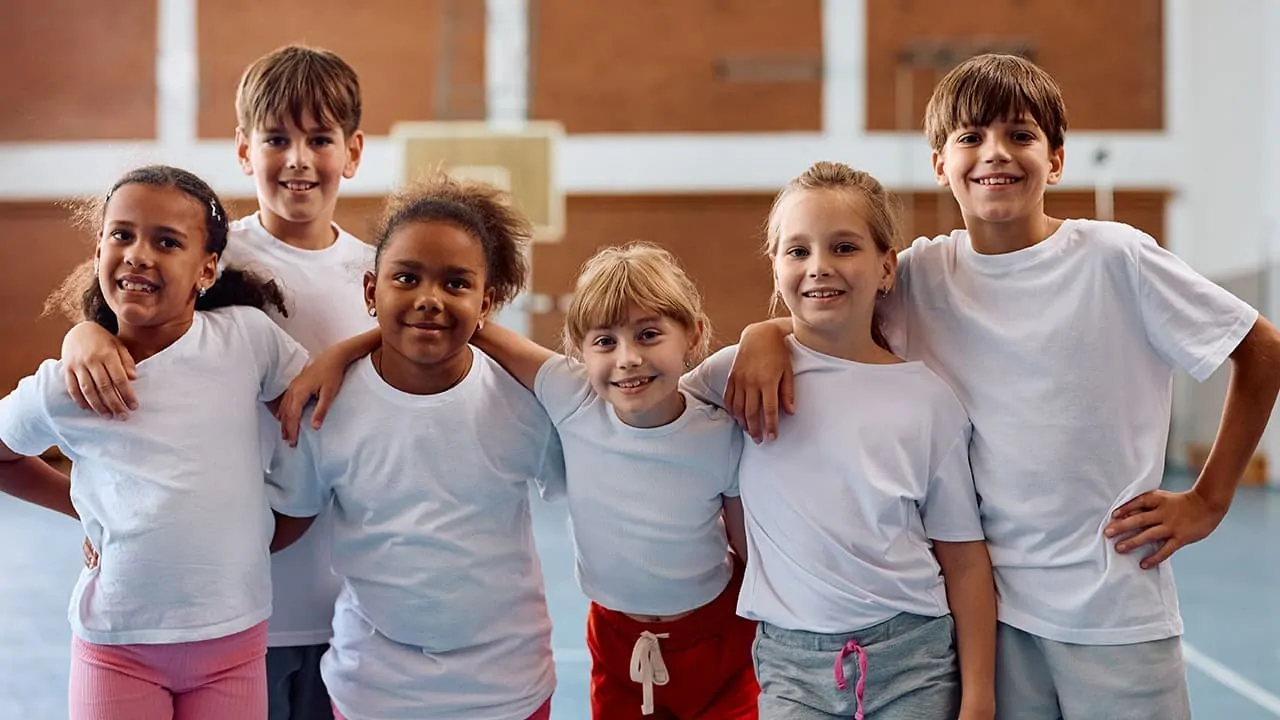 a group of kids gymnasts standing in their play area