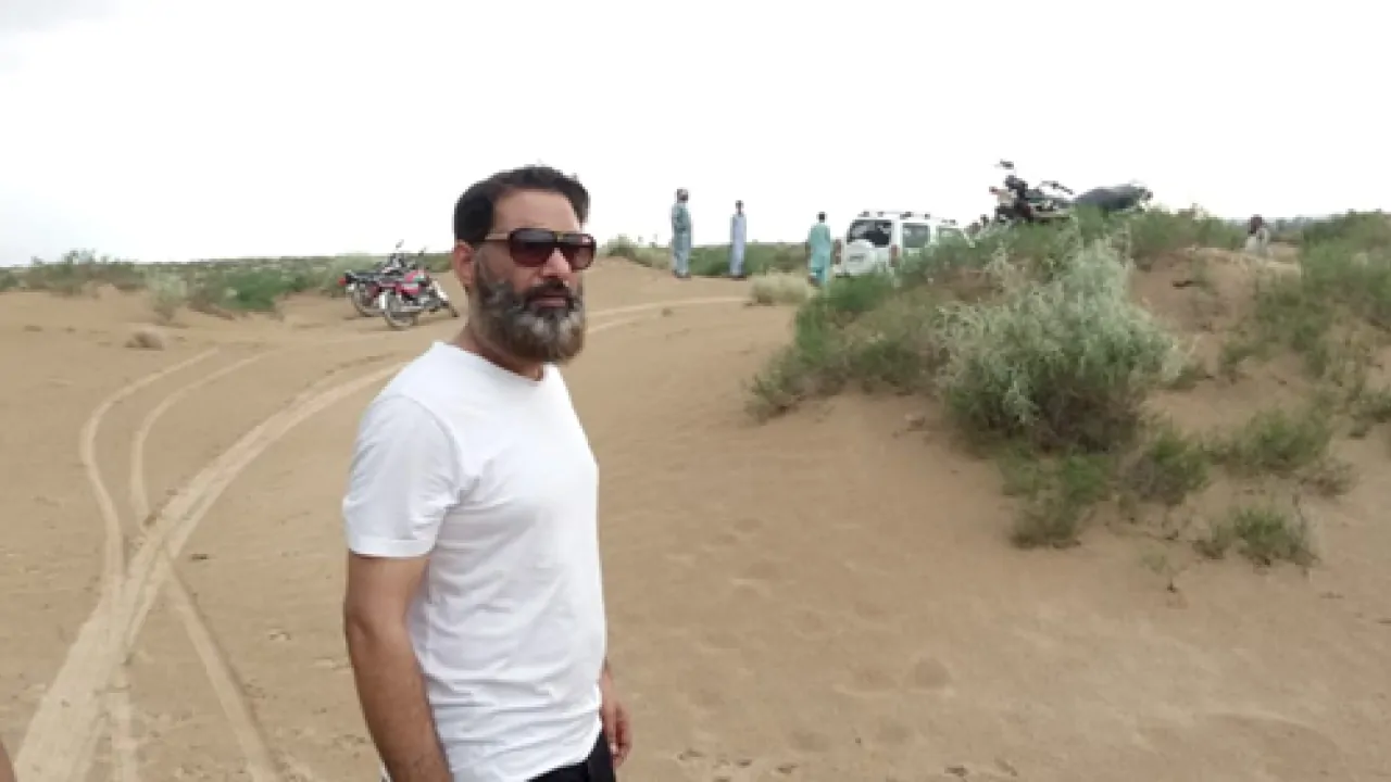 Side pose of a man wearing white t-shirt