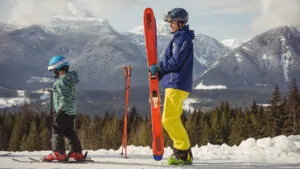 A man and his child skiing together